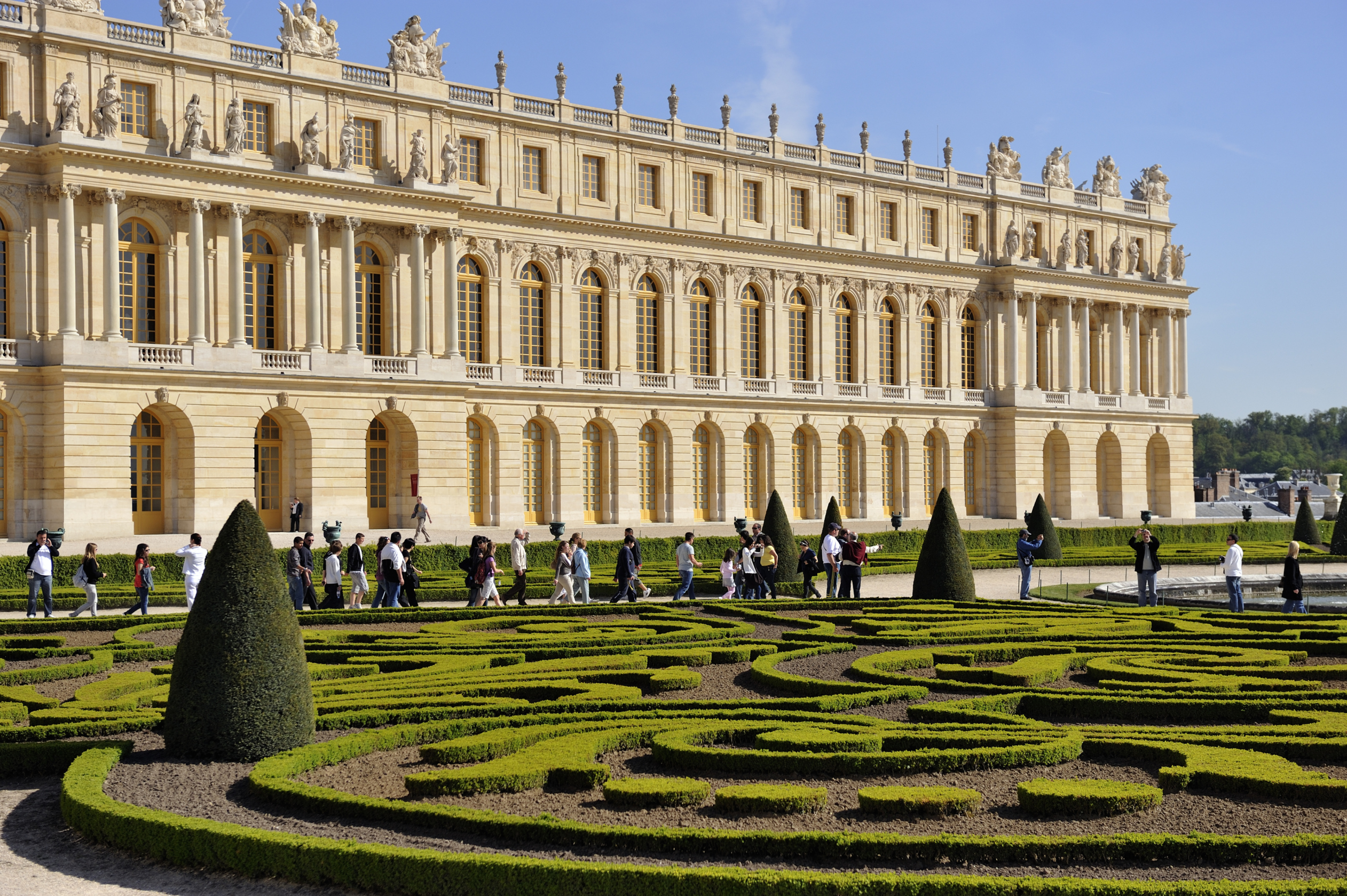 The opulent Palace of Versailles with manicured gardens and fountains