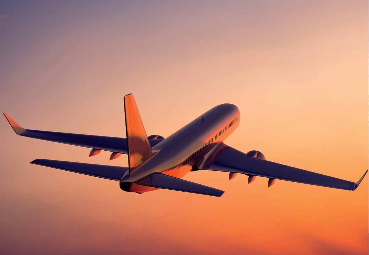 Airplane taking off and flying into the sky with clouds in the background